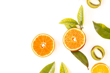 Orange cut next to green leaves