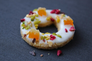 one shortbread cookies with candied fruits on a dark background