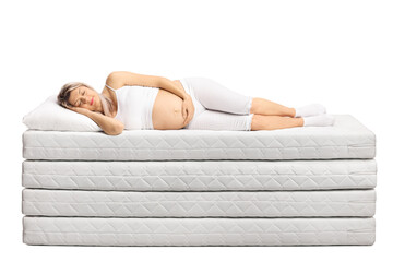 Pregnant woman in pajamas sleeping on a pile of mattresses