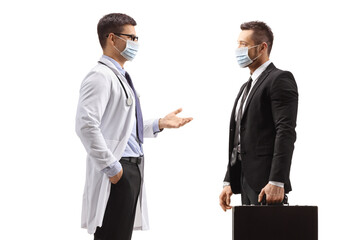 Male doctor and businessman with medical face masks standing and talking