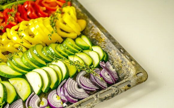 Raw Sheet pan vegetables, roasted vegetables in the oven background, vegan cuisine recipe, healthy food concept