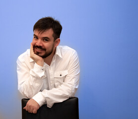 Young bearded man holding his face with one hand