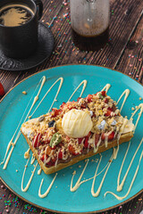 belgium waffles with strawberry and banana and a cup of coffee