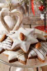 Gingerbread cookies in star shape decorated with almonds.