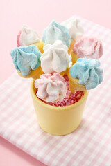 Marshmallow cake pops on pink background.