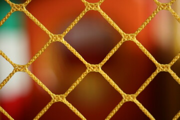 Fototapeta premium Yellow braided net in the foreground