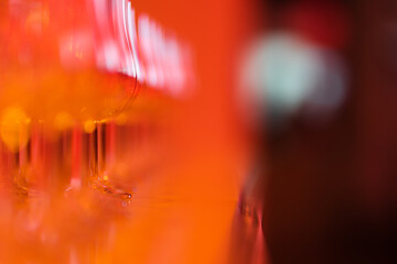 Empty classic whiskey glasses on the bar in a bright red glow
