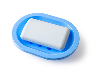 Blue dish with soap isolated on a white background. New rectangle soap bar on a rounded plastic holder with drain for bathroom and shower. Washing hands, purity and toiletries concepts.