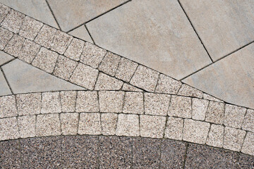 Combination of different materials in paving. Сoncrete slab and paving tiles top view.