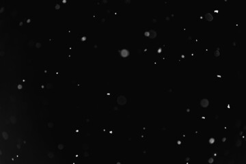 Snow on the black sky at night.