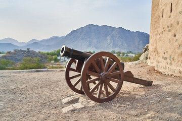 Fototapeta premium an old cannon stands near the old fortress