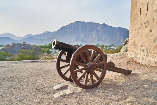 an old cannon stands near the old fortress