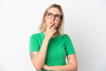 Young caucasian woman isolated on white background With glasses and having doubts
