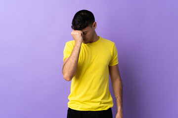 Young Colombian man isolated on purple background with headache