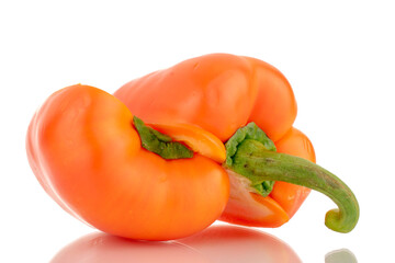 Two halves of fresh orange sweet peppers, close-up, isolated on white.
