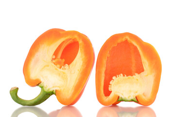 Two halves of fresh orange sweet peppers, close-up, isolated on white.