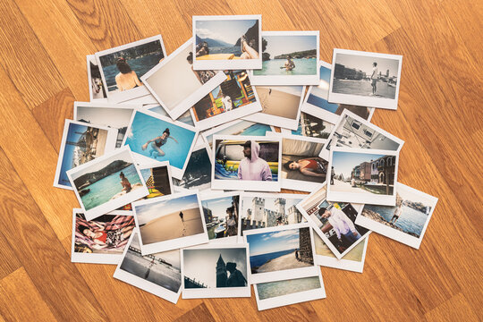 Group of holidais photo collage. Printed pictures of holidays. Printed photos on wooden background