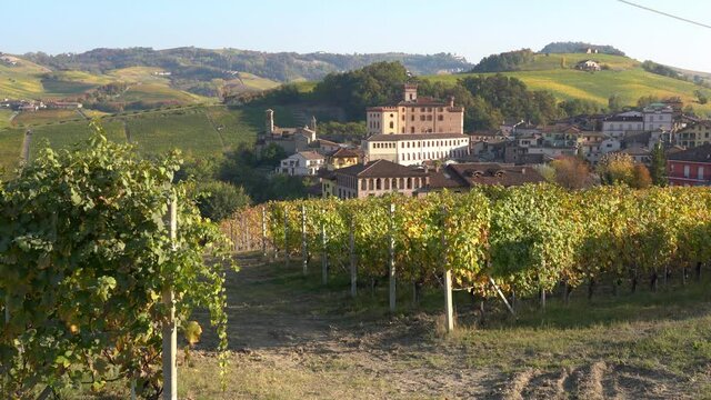 Beautiful hills and vineyards during fall season surrounding Barolo village. In the Langhe region, Cuneo, Piedmont, Italy.