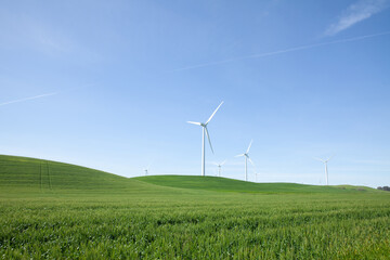 Fototapeta na wymiar Wind turbine with blue sky