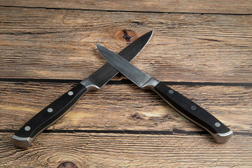 Kitchen knives for cooking on a wooden background.