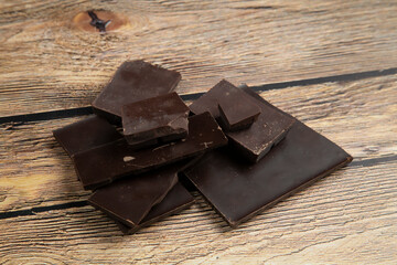 Dark chocolate on a wooden background. Dessert for home.