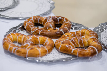 Freshly baked pretzels, kringles on plate at cuisine of cafe, restaurant or bakery. Pastry, pastry, culinary, gastronomy and food concept