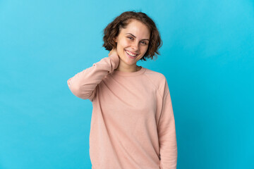 Young English woman isolated on blue background laughing