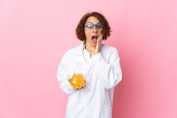 Young English scientific woman isolated on pink background with surprise and shocked facial expression