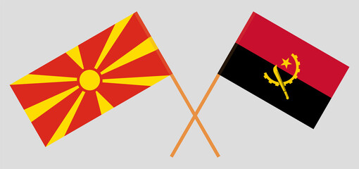 Crossed flags of North Macedonia and Angola. Official colors. Correct proportion