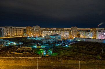 the outskirts of the city at night with illumination
