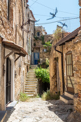 Ancient streets to houses in Bussana Vecchia damaged and earthquake with plants and flowers
