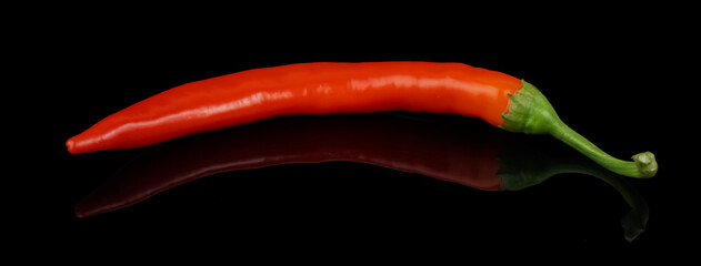 Ripe hot chili peppers, red, on a black background in isolation with delight