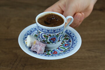female hand serve traditional Turkish cofffee with Turkish delight