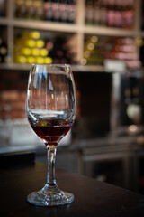 Glass of red wine on a bar in winery. Wine aroma tasting