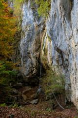 Small waterfall over limestone cliff
