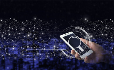 Searching information data on internet networking concept. Hand hold white smartphone with digital hologram search data sign on city dark blurred background.