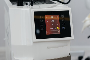 Modern laser in a beauty salon close-up. Laser pulses cleanse the skin. Hardware cosmetology. The process of photothermolysis, warming the skin. Facial skin rejuvenation.
