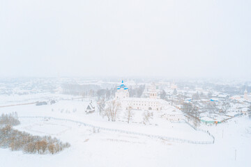 Aerial drone view of Suzdal Kremlin and cathedral of Nativity at the Kamenka river, Russia during winter with snow. Suzdal golden ring of Russia
