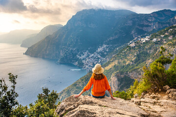 Young girl on Positano coast background, Amalfi, Italy - obrazy, fototapety, plakaty
