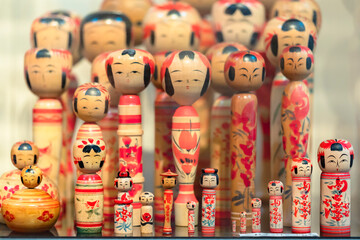 Various kind of traditional hand painted wooden kokeshi dolls with no arms or legs from all around...