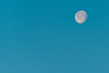 Moon in the blue, morning sky.