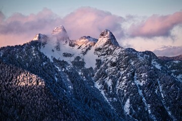 Fototapeta na wymiar Famous The Lions Peaks near Vancouver covered with snow in sunset. British Columbia. Canada