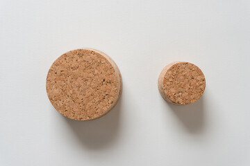 two cork stoppers on a light background