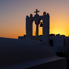 A traditional church steeple at sunset in Ios, Greece