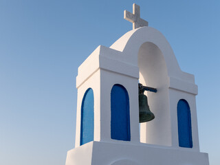 A traditional church steeple at sunset in Ios, Greece