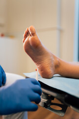 Chiropodist exploring a patient with diabetic foot in the medical center.