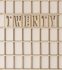 the number 20 spelled out in wooden stencil font inside a grid