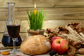 Christmas oak tree, candle, bread and dried fruits