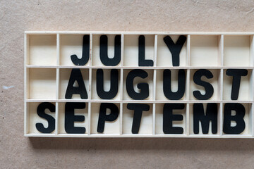 the months of july, august, september arranged in a shallow box