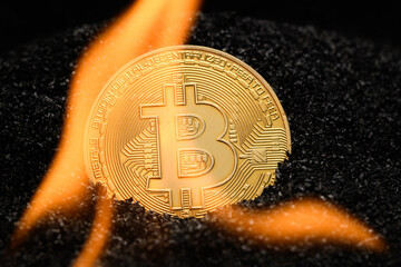 Burning Bitcoin. Golden Bitcoin coin in real flames. Bitcoin on fire. Burning BTC cryptocurrency
